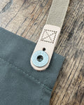 Doughnut hole buttons for removable straps.