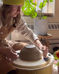 Earthen Joy (Minneapolis, MN) wearing copper pottery apron. 
